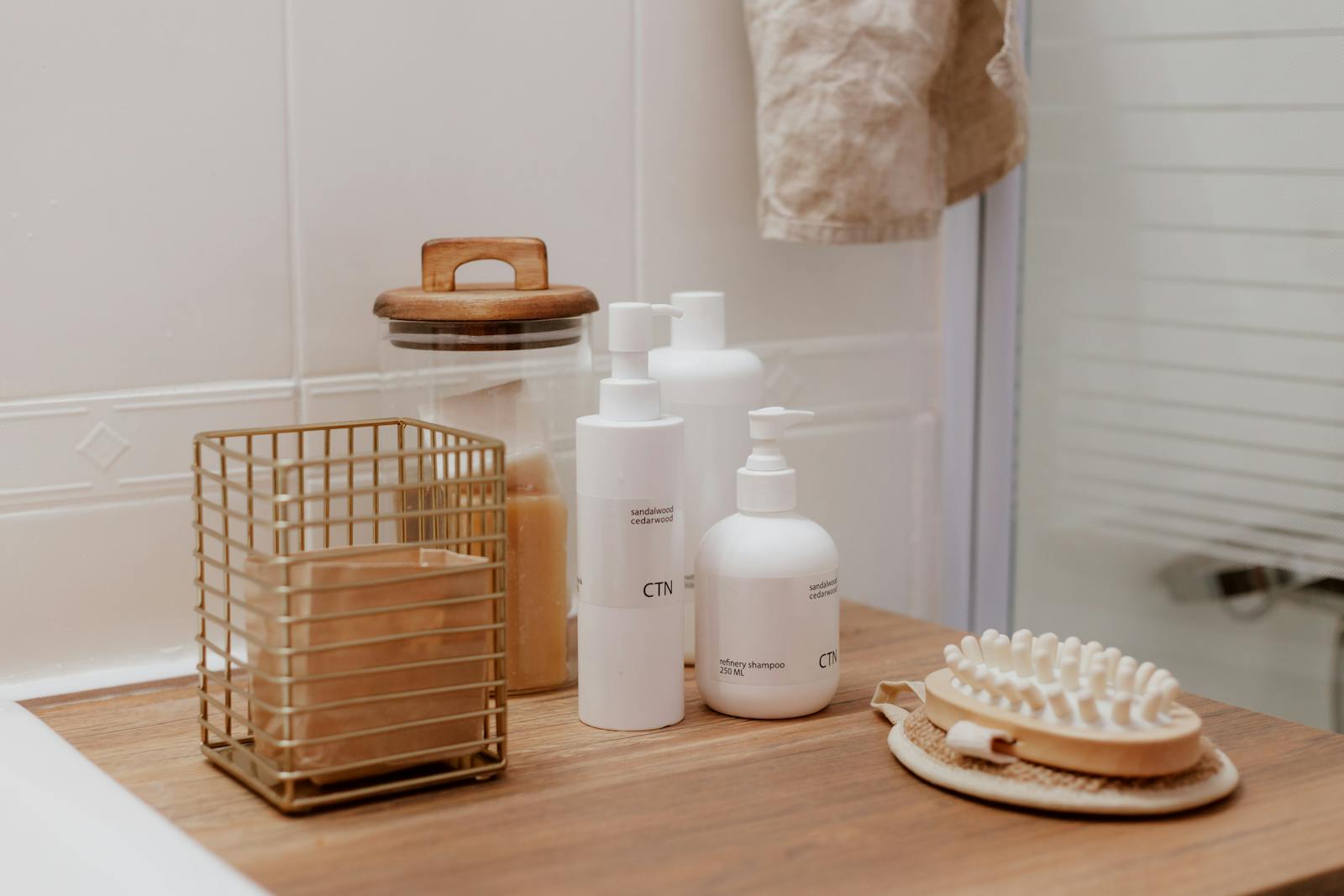Stylish bathroom arrangement featuring cosmetic bottles and toiletries on a wooden surface.