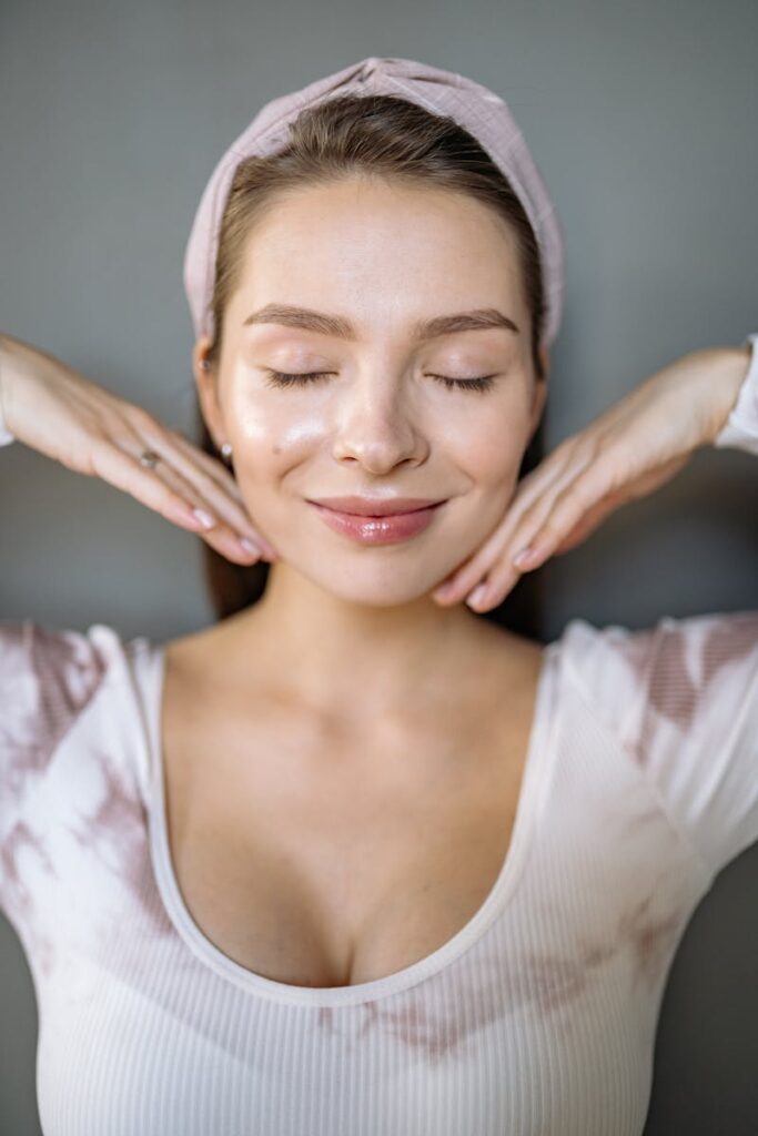 A serene portrait of a smiling woman with eyes closed, displaying elegance and tranquility.