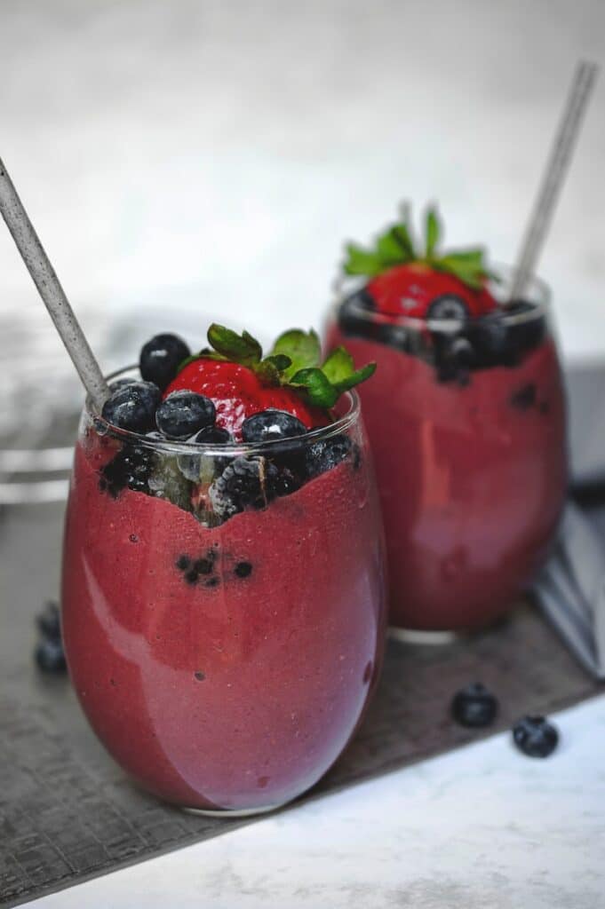 two glasses with fruit in it