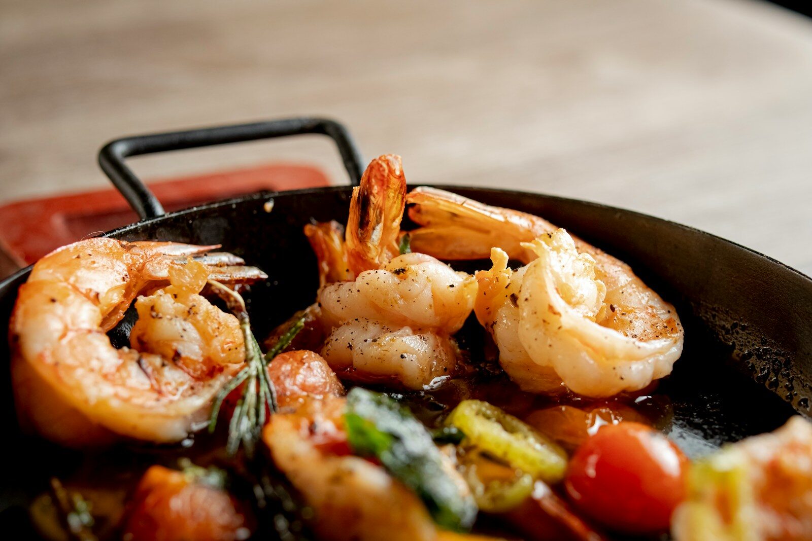 Cooked shrimp with tomatoes and herbs in a pan
